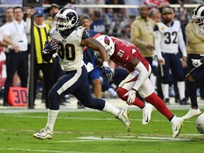 Todd Gurley II of the Los Angeles Rams runs with the ball against the Arizona Cardinals during the second half at State Farm Stadium on December 1, 2019 in Glendale, Arizona.