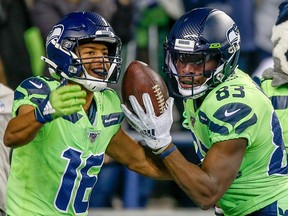Seahawks wide receiver David Moore (right) celebrates a touchdown with  teammate Tyler Lockett in the third quarter against the Minnesota Vikings in Seattle last night.  Getty Images