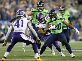 Running back Rashaad Penny, right, of the Seattle Seahawks carries the ball against the defense of the Minnesota Vikings at CenturyLink Field on Dec. 2, 2019 in Seattle, Wash. (Otto Greule Jr/Getty Images)