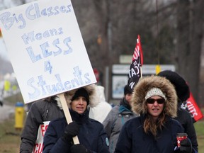 Picketers walk outside Great Lakes high school in Sarnia on Dec. 4, part of a one-day strike by Ontario Secondary School Teachers' Federation (OSSTF) members across the province.  Tyler Kula/Postmedia Network