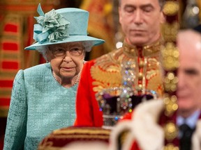 Britain's Queen Elizabeth II walks behind the Imperial State Crown while proceeding through the Royal Gallery,  during the opening of Parliament in London on  Dec. 19, 2019. (AFP via Getty)