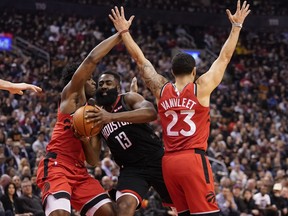 Houston Rockets guard James Harden, centre, drives between Toronto Raptors forward OG Anunoby, left, and guard Fred VanVleet, right, during the first half at Scotiabank Arena, Dec. 5, 2019. (John E. Sokolowski-USA TODAY Sports)