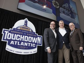 Anthony LeBlanc, Founding Partner, Schooners Sports and Entertainment, Randy Ambrosie, CFL Commissioner, and Greg Turner, Councillor-at-Large and Deputy Mayor, City of Moncton pose for a photo at a press conference in Moncton, N.B., on March 29, 2019.