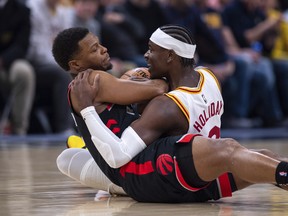 Indiana Pacers guard Aaron Holiday (right) and Toronto Raptors guard Kyle Lowry battle for the ball on Monday night in Indianapolis. (Doug McSchooler/The Associated Press)