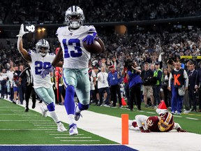 Michael Gallup of the Dallas Cowboys scores one of his three touchdown on Sunday. (GETTY IMAGES)