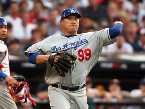National League pitcher Hyun-Jin Ryu (99) of the Los Angeles Dodgers throws to first base for the out against the American League during the first inning in the 2019 MLB All Star Game at Progressive Field. Mandatory Credit: Charles LeClaire-USA TODAY