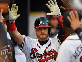 Atlanta Braves third baseman Josh Donaldson is greeted in the dugout after hitting a home run against the St. Louis Cardinals in the fourth inning of game five of the 2019 NLDS playoff baseball series at SunTrust Park.