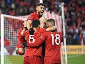 Toronto FC midfielder Jonathan Osorio (21) celebrates after an extra time goal by midfielder Richie Laryea (22) against DC United at BMO Field. Gerry Angus-USA TODAY