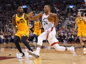 Raptors guard Norman Powell (24) drives to the net against Utah Jazz guard Donovan Mitchell (45) during the first half at Scotiabank Arena on Sunday. John E. Sokolowski-USA TODAY Sports