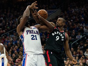 Philadelphia 76ers' Joel Embiid (21) and Toronto Raptors forward Serge Ibaka (9) battle for the ball during the second quarter at Wells Fargo Center on Sunday night. Bill Streicher-USA TODAY Sports