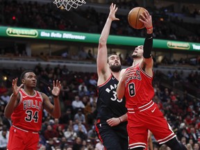 Chicago Bulls guard Zach LaVine (8) goes to the basket against Toronto Raptors centre Marc Gasol (33) during the first half at United Center. Mandatory Credit: Kamil Krzaczynski-USA TODAY Sports