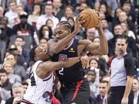 LA Clippers forward Kawhi Leonard (2) controls a ball as Toronto Raptors guard Kyle Lowry (7) tries to defend during the third quarter at Scotiabank Arena. Nick Turchiaro-USA TODAY Sports