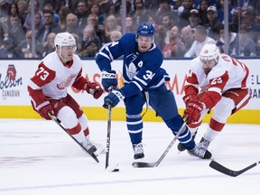 Toronto Maple Leafs centre Auston Matthews (34) skates between Detroit Red Wings left wing Brendan Perlini (29) and Detroit Red Wings left wing Adam Erne (73) during the third period at Scotiabank Arena. Nick Turchiaro-USA TODAY