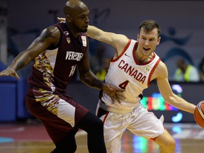 Canada’s Brady Heslip (right) is challenged by Venezuela’s Miguel Ruiz during a FIBA’s Americas qualifier match in China in 2018.  Getty Images