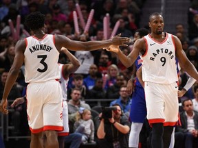 Toronto Raptors forward Serge Ibaka high fives forward OG Anunoby during the third quarter against the Detroit Pistons at Little Caesars Arena.