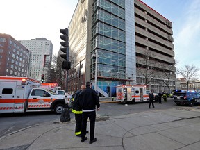 Emergency personnel at the scene of an incident at the Renaissance Park Garage where an adult and two children fell from the garage and were found dead on a sidewalk near the Boston parking garage on Christmas Day, Wednesday, Dec. 25, 2019.