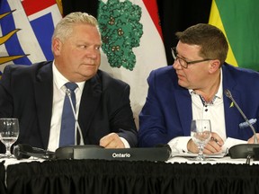 Canada's Premiers - The Council of the Federation meetings held in Toronto (Pictured) Saskatchewan Premier Scott Moe speaks with Ontario Premier Doug Ford (L)  on Monday December 2, 2019. Jack Boland/Toronto Sun/Postmedia Network