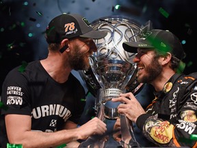 Crew chief Cole Pearn (left) and driver Martin Truex Jr. celebrate winning the Monster Energy Cup Series Championship at Homestead, Fla., in 2017. (GETTY IMAGES)