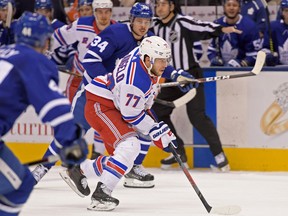 New York Rangers defenceman Tony DeAngelo (77) skates the puck past Toronto Maple Leafs forward Auston Matthews (34)  at Scotiabank Arena on Saturday night. (Dan Hamilton/USA TODAY Sports)