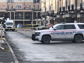 Police collect evidence at the scene of a deadly shooting outside a townhome on Chevron Prince Path in Oshawa on Tuesday.