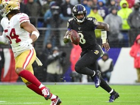Baltimore Ravens quarterback Lamar Jackson runs with the ball in the first quarter against the San Francisco 49ers at M&T Bank Stadium.