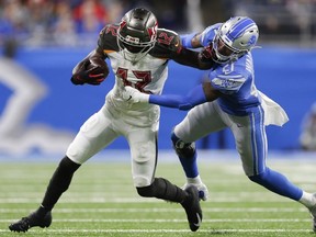 Tampa Bay Buccaneers wide receiver Chris Godwin stiff arms Detroit Lions defensive back Tracy Walker during the second quarter at Ford Field.