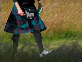 In this July 10, 2019 file phot, a spectator wearing a kilt walks the first hole during the pro-am event prior to the start of the Aberdeen Standard Investments Scottish Open at The Renaissance Club in North Berwick, Scotland. (Kevin C. Cox/Getty Images)