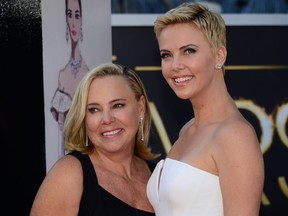 Actress Charlize Theron, right, and her mother arrive on the red carpet for the 85th Annual Academy Awards on Feb. 24, 2013 in Hollywood, Calif. (FREDERIC J. BROWN/AFP via Getty Images)