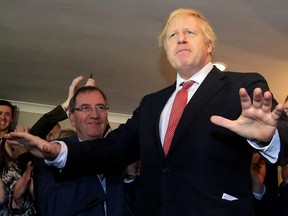 Britain's Prime Minister Boris Johnson gestures as he speaks to supporters on a visit to meet newly elected Conservative party MP for Sedgefield, Paul Howell, at Sedgefield Cricket Club in County Durham, north east England on December 14, 2019, following his Conservative party's general election victory.