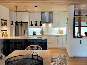 White cabinetry, the addition of a wet bar area, new appliances and Hanstone quartz set the scene.