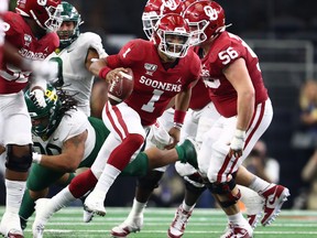 Oklahoma quarterback Jalen Hurts threw for 287 yards and ran for another 38 in a 30-23 overtime win over Baylor in the Big 12 Championship in Arlington, Texas, yesterday. (USA Today)
