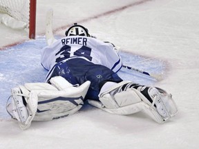 Toronto Maple Leafs goalie James Reimer lays on the ice after getting beat on the game-winning goal by Boston Bruins centre Patrice Bergeron during overtime in Game 7 of their playoff series in Boston, Monday, May 13, 2013. (THE ASSOCIATED PRESS FILES)