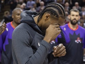 Kawhi Leonard pretends to cry as he accepts his Raptors championship ring at Scotiabank Arena.  STAN BEHAL/TORONTO SUN
