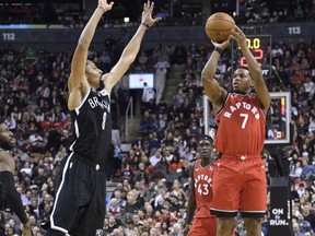 Raptors guard Kyle Lowry (right) shoots as Nets guard Spencer Dinwiddie (left) tries to defend during second quarter NBA action at Scotiabank Arena in Toronto, Saturday, Dec. 14, 2019.