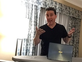 Author Marc Saltzman improvises a 'standing desk' using a hotel room ironing board
