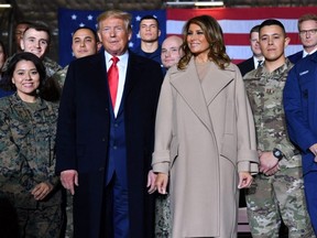 U.S. President Donald Trump stands with First Lady Melania Trump after signing the "National Defense Authorization Act for FY2020" at Joint Base Andrews, Maryland on Dec. 20, 2019.