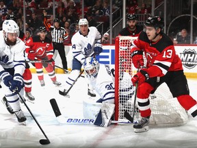 Maple Leafs defenceman Jake Muzzin keeps an eye on New Jersey Devils centre Nico Hischier on Friday night in Newark. Muzzin broke a bone in his foot blocking a shot and is week-to-week. (Photo by Bruce Bennett/Getty Images)