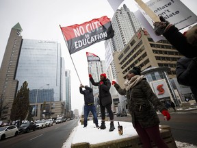 Striking teachers are seen picketing outside of the Toronto District School Board head office on Yonge Street in Toronto, Wednesday, Dec. 4, 2019. Hundreds of thousands of high school students will be out of class Wednesday as their teachers hold a one-day strike to protest the lack of progress in contract talks between their union and Premier Doug Ford's government.