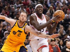 Raptors forward Pascal Siakam (right) drives to the net against Jazz forward Joe Ingles (left) during first half NBA action at Scotiabank Arena in Toronto on Sunday, Dec. 1, 2019.