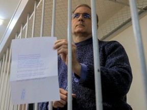 Canadian citizen and former U.S. Marine Paul Whelan, who was detained and accused of espionage, stands inside a defendants' cage before a court hearing on extending his pre-trial detention, in Moscow, on Oct. 24, 2019.