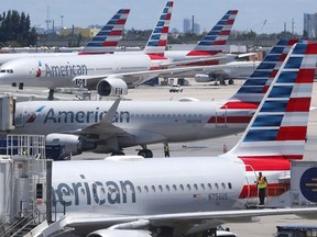 In this April 24, 2019, photo, American Airlines aircraft are shown parked at their gates at Miami International Airport in Miami.