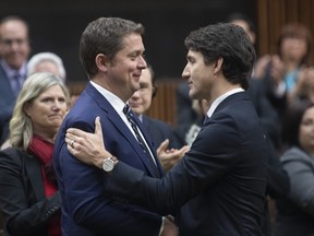 Prime Minister Justin Trudeau shakes hands with Andrew Scheer after Scheer announced he will step down as leader of the Conservatives, Thursday December 12, 2019 in the House of Commons in Ottawa.