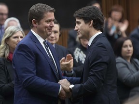 Prime Minister Justin Trudeau shakes hands with Leader of the Opposition Andrew Scheer after he announced he will step down as leader of the Conservatives, Thursday December 12, 2019 in the House of Commons in Ottawa. THE CANADIAN PRESS/Adrian Wyld ORG XMIT: ajw106 ORG XMIT: POS1912121145163119
