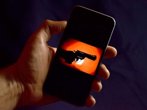 device with gun image on the screen in dark environment