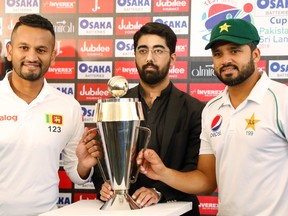 Sri Lanka captain Dimuth Karunaratne (left) and Pakistan captain Azhar Ali (right) pose with the Test series trophy ahead of the first Test cricket match between Pakistan and Sri Lanka at Pindi Cricket Stadium on Dec. 10, 2019. REUTERS