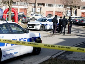 Peel Regional Police investigate a stabbing that left two men dead at an apartment and townhouse complex on Glen Erin Dr. in Mississauga on Saturday, Dec. 28, 2019. (Veronica Henri/Toronto Sun/Postmedia Network)