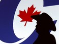 A forum visitor is silhouetted in front of a projected logo before a Conservative Party leadership candidate forum at the Deerfoot Inn and Casino in Calgary, March 1, 2017.