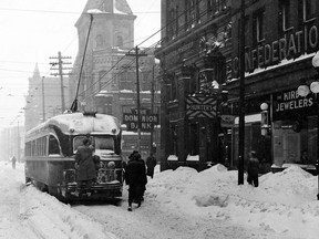One of the TTC’s reliable PCC streetcars makes its way east along Queen St., through the Victoria St. intersection and the remnants of the December 11-12, 1944 snow storm. Talk about fare evaders…
