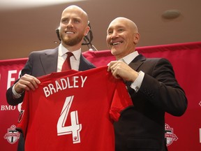 Toronto FC captain Michael Bradley poses with team president Bill Manning after signing a new contract in Toronto, Ont. on Thursday December 12, 2019. Jack Boland/Toronto Sun/Postmedia Network