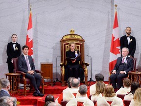 Canada's Gov. Gen. Julie Payette (C) delivers the speech from the throne as Prime Minister Justin Trudeau (L) and Sen. Peter Harder (2R) look on at the Senate of Canada on Dec. 5, 2019 in Ottawa.